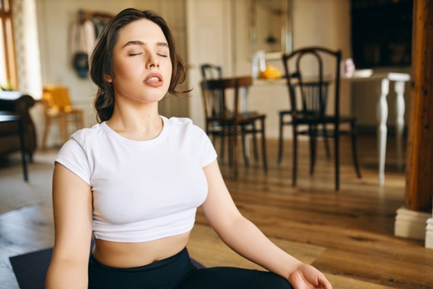 a woman practicing harmful deep breathing exercises