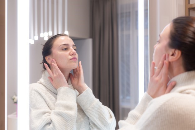 a woman using Buteyko Breathing Techniques during her skincare routine